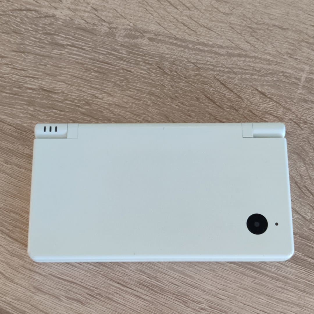 A white Nintendo DSi handheld game console.