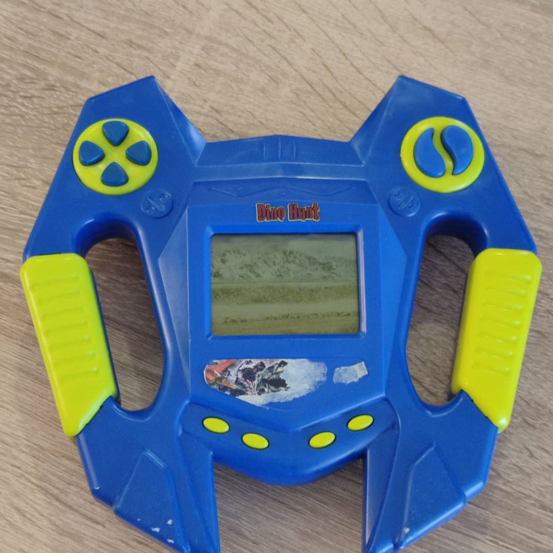 Vintage Dino Hunt handheld game with LCD screen and blue & yellow design.