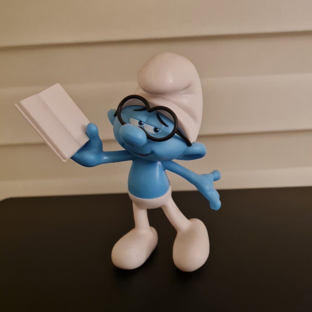 Brainy Smurf figurine holding a book.