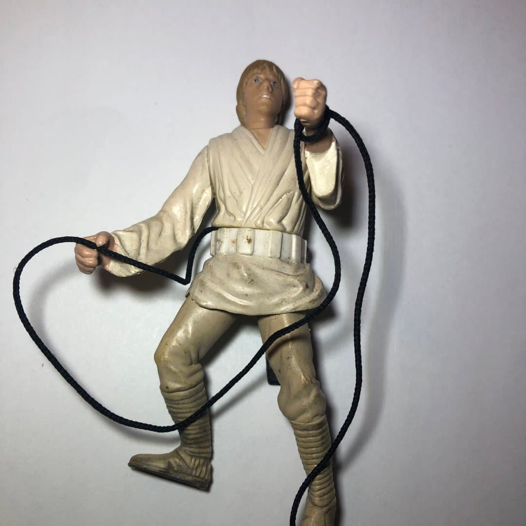 Vintage Luke Skywalker action figure with grappling hook.