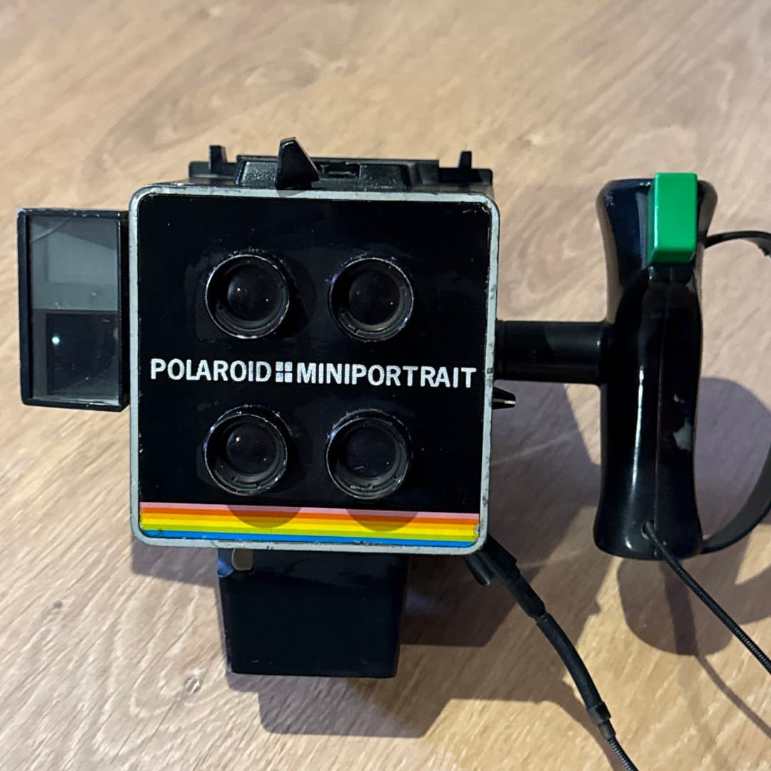 Polaroid Miniportrait vintage camera with four lenses for instant multi-image photography.