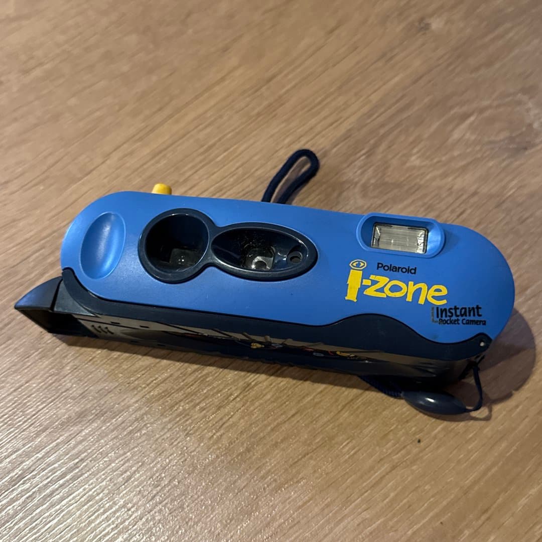 Blue Polaroid i-Zone Instant Pocket Camera for classic instant photos.