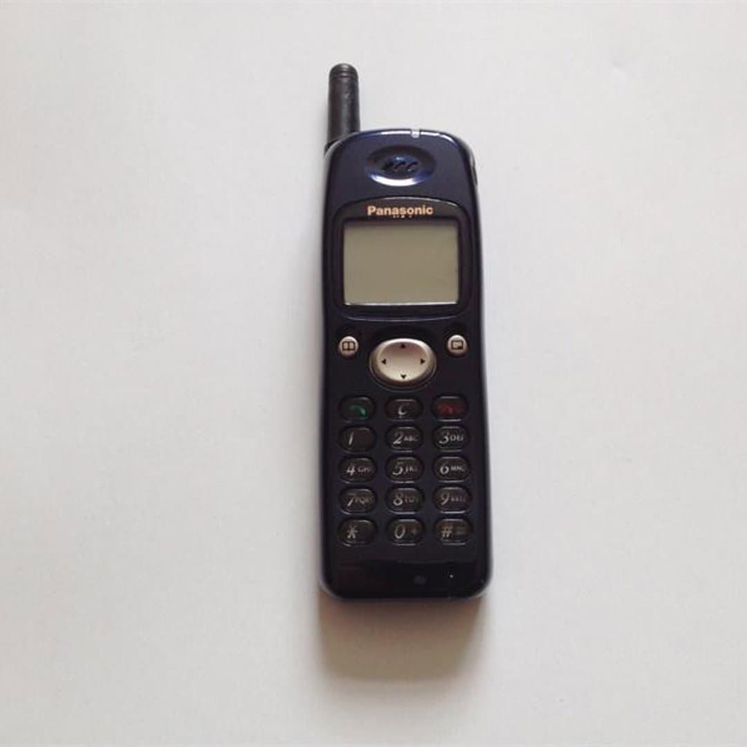 Panasonic GD90 - Vintage Panasonic mobile phone with an external antenna and monochrome screen.