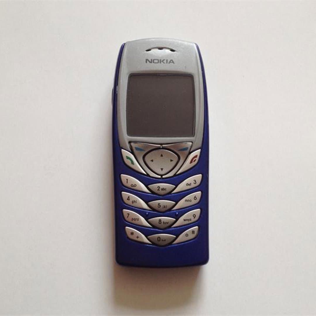 Nokia 6100 - A classic blue Nokia feature phone, known for its compact design and iconic keypad. - Photo 1