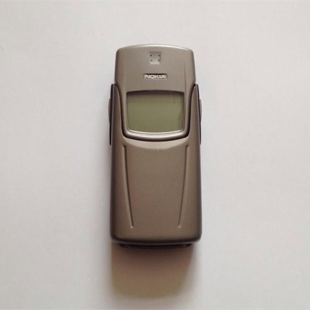 Classic Nokia 8910 mobile phone with a metallic finish and sliding keypad cover. - Photo 1