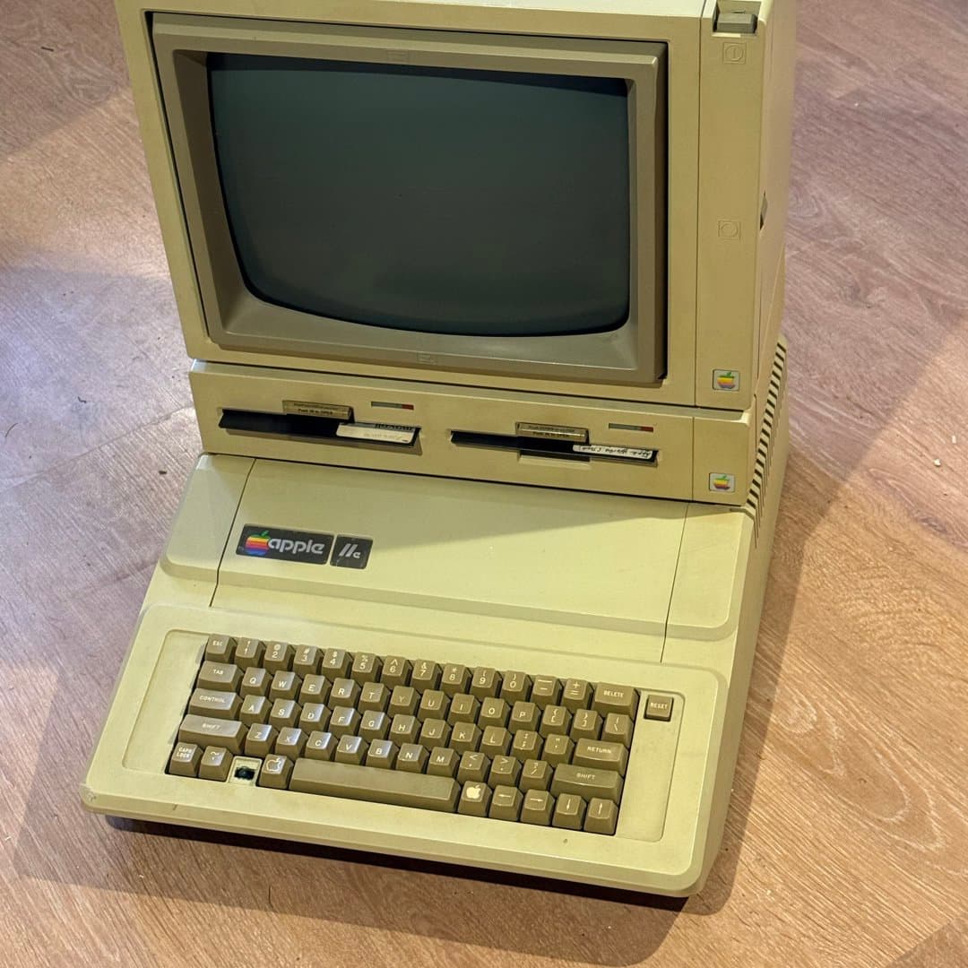 Vintage Apple IIe personal computer system with monitor and dual floppy drives. - Photo 1
