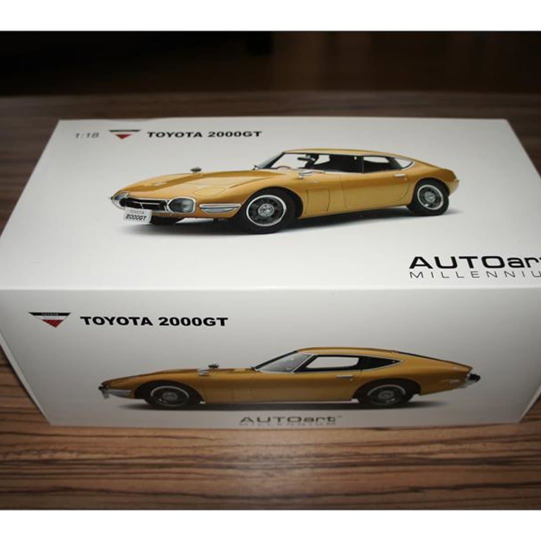 Detailed 1:18 scale AUTOart Millennium model of a classic gold Toyota 2000GT.