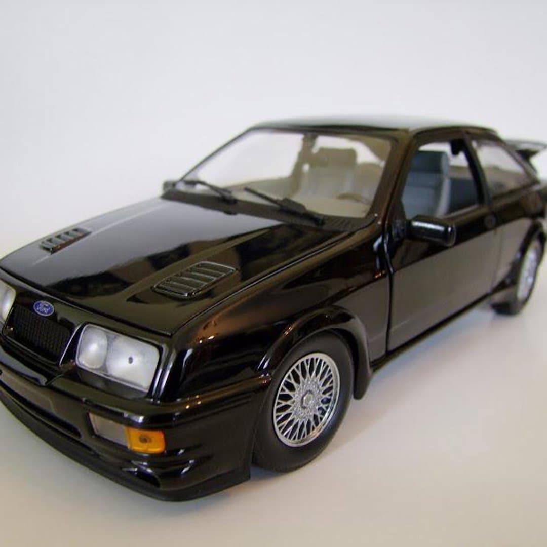 Minichamps Black Ford Sierra RS Cosworth 1/18 die-cast model car with detailed features.