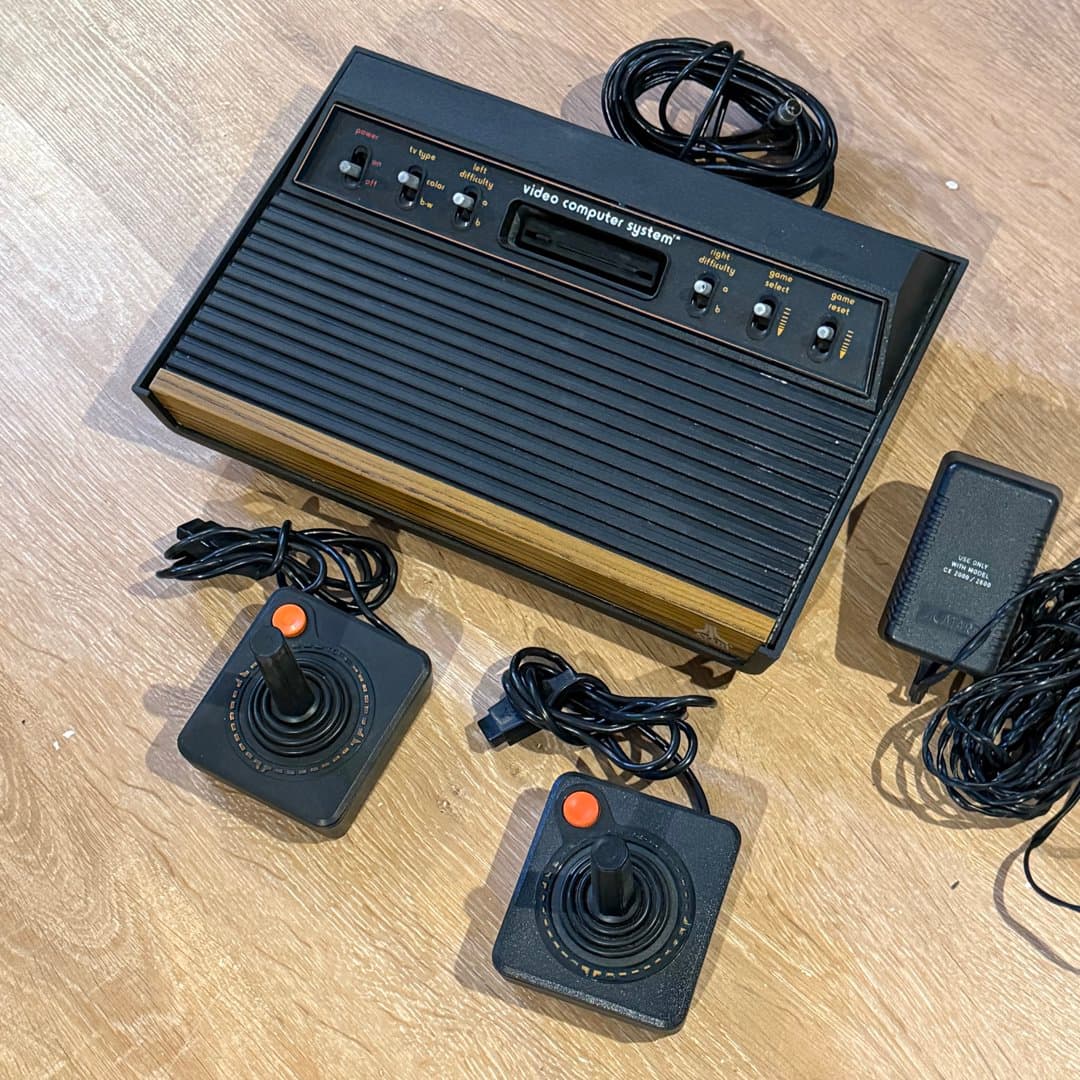 Classic Atari 2600 woody 6 switch video game console with joysticks, a retro gaming icon.