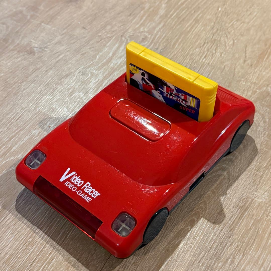 Red car-shaped "Video Racer" famiclone video game console with an F-1 Hero Super cartridge. - Photo 1