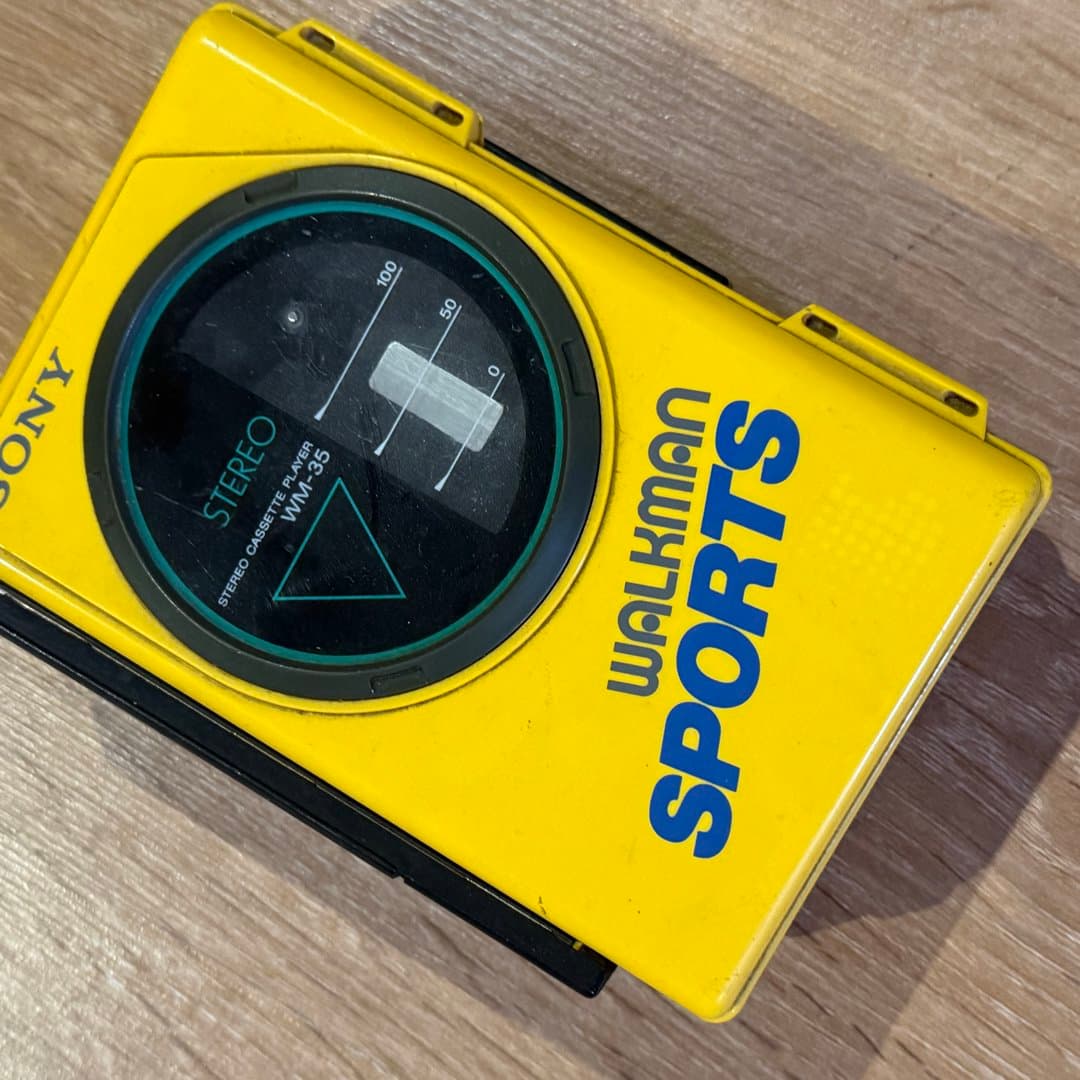 Retro yellow Sony Walkman Sports WM-35 portable stereo cassette player.