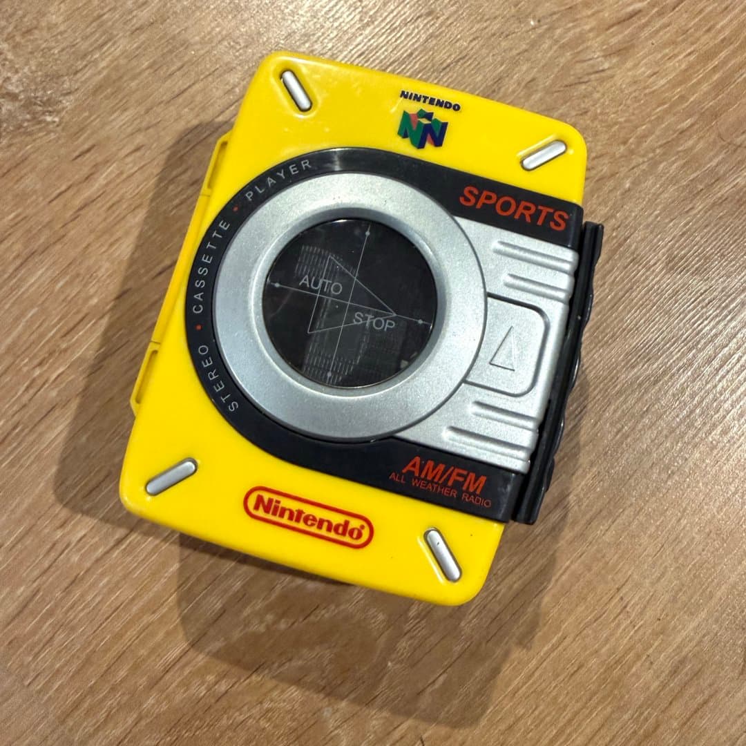 A yellow Nintendo N64 branded stereo cassette player with AM/FM all-weather radio. - Photo 1