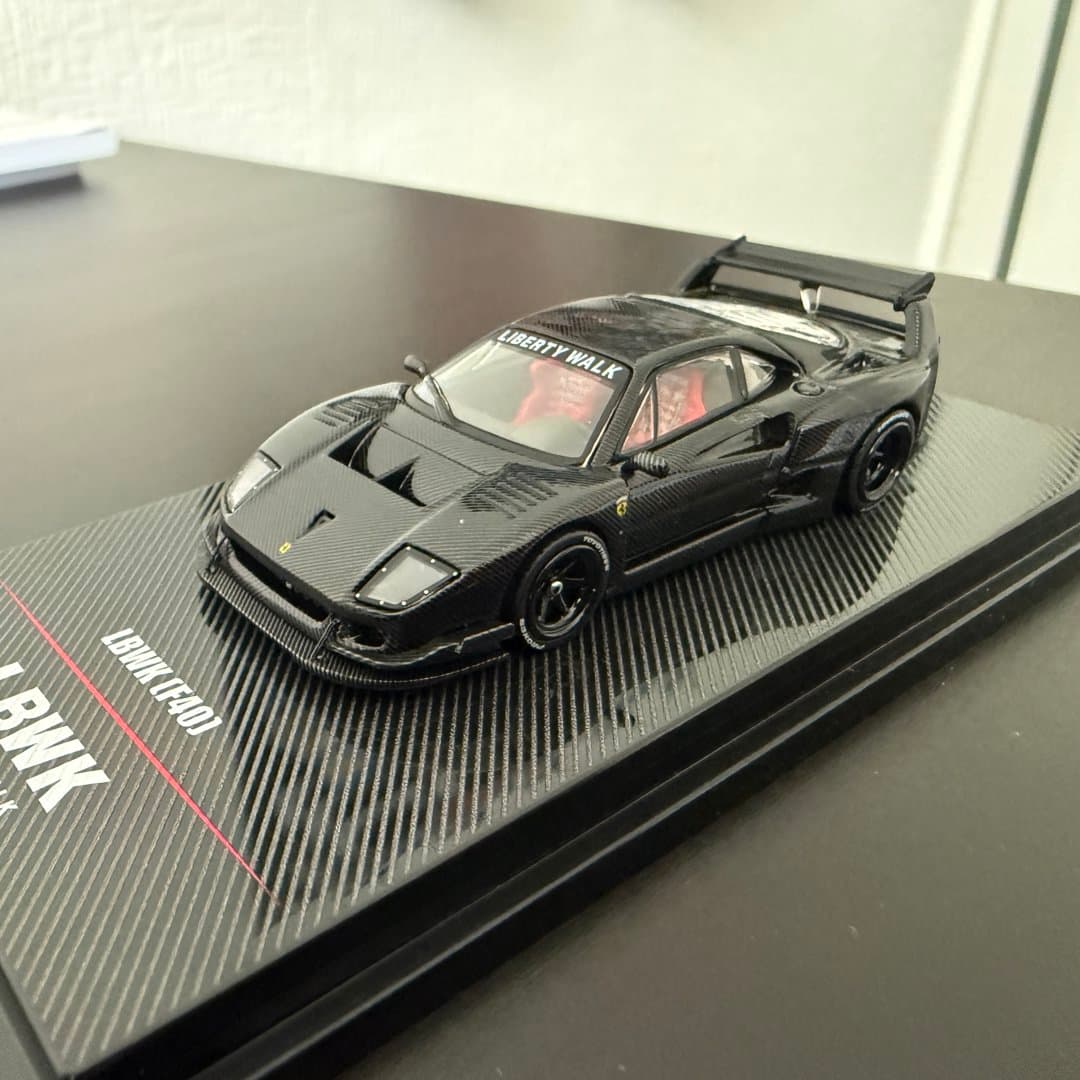 A detailed black Liberty Walk Ferrari F40 scale model car on a display base. - Photo 1