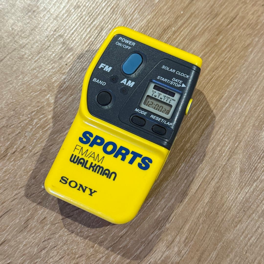 Yellow Sony Sports FM/AM SRF-9 Walkman radio with solar clock and stopwatch function.