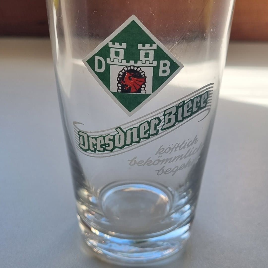 Dresdner Biere branded glass with 0.25L fill line, perfect for enjoying German beer.