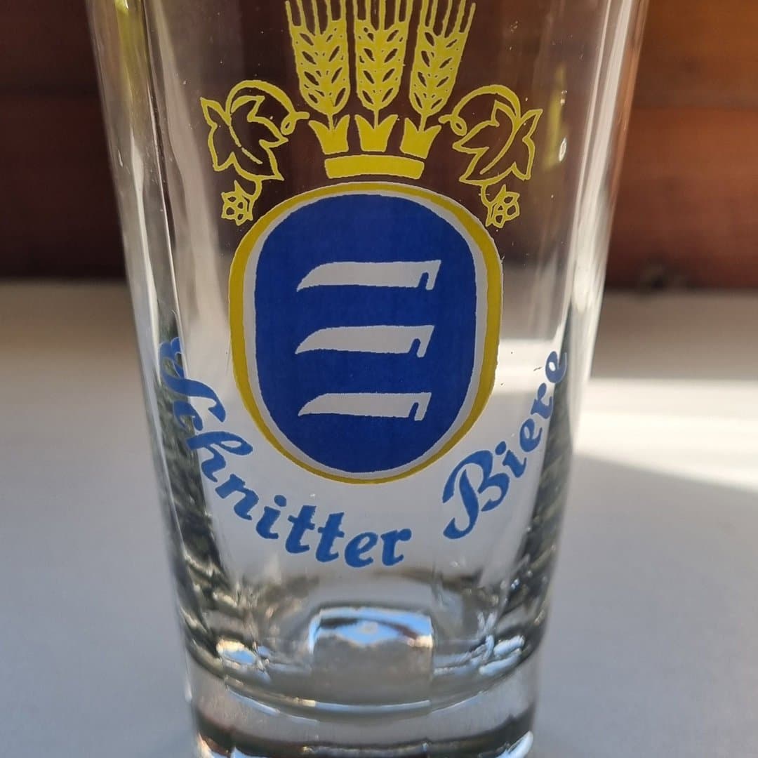 Clear 0.2L Schnittter Biere branded beer glass with distinctive wheat and crown logo.