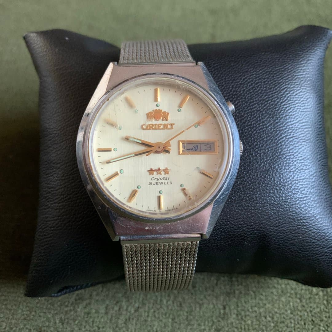 Vintage Orient Crystal 21 Jewels automatic watch with day-date, Arabic day, and mesh bracelet.