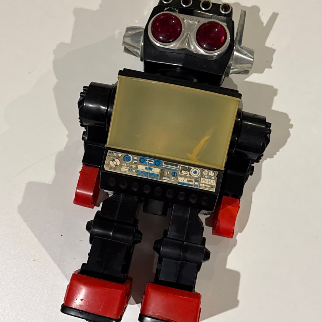 Vintage toy robot with red and black color scheme.