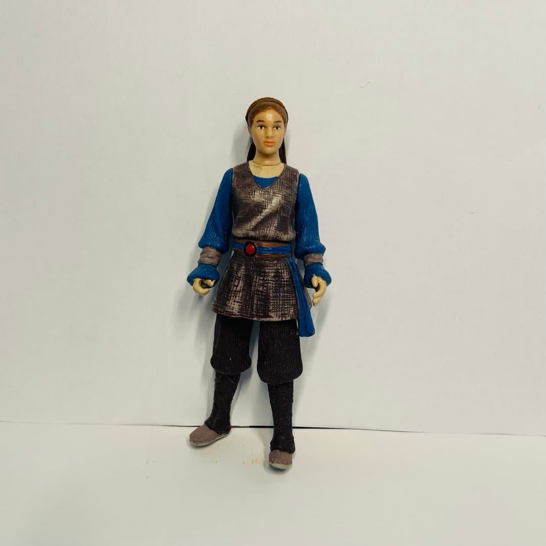 Star Wars Rey action figure in blue and brown outfit, a collectible toy for fans.