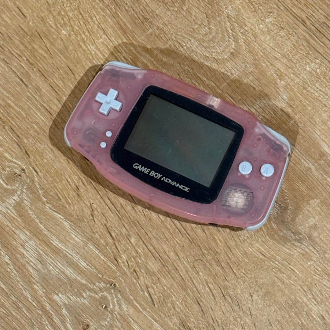 Vintage pink translucent Nintendo Game Boy Advance (AGB-001) handheld console.
