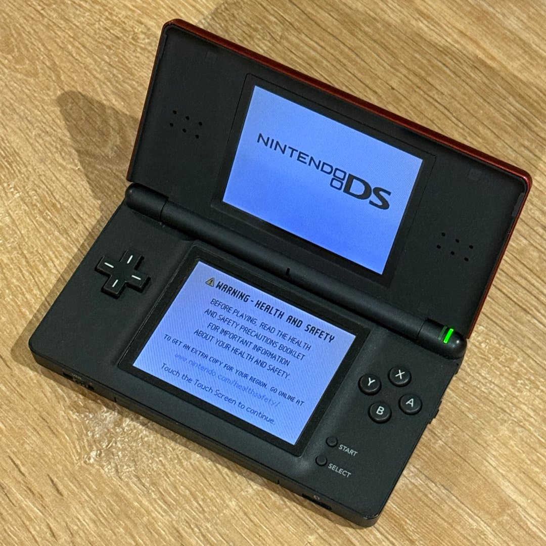 Classic Nintendo DS Lite handheld gaming console with dual game card slots.