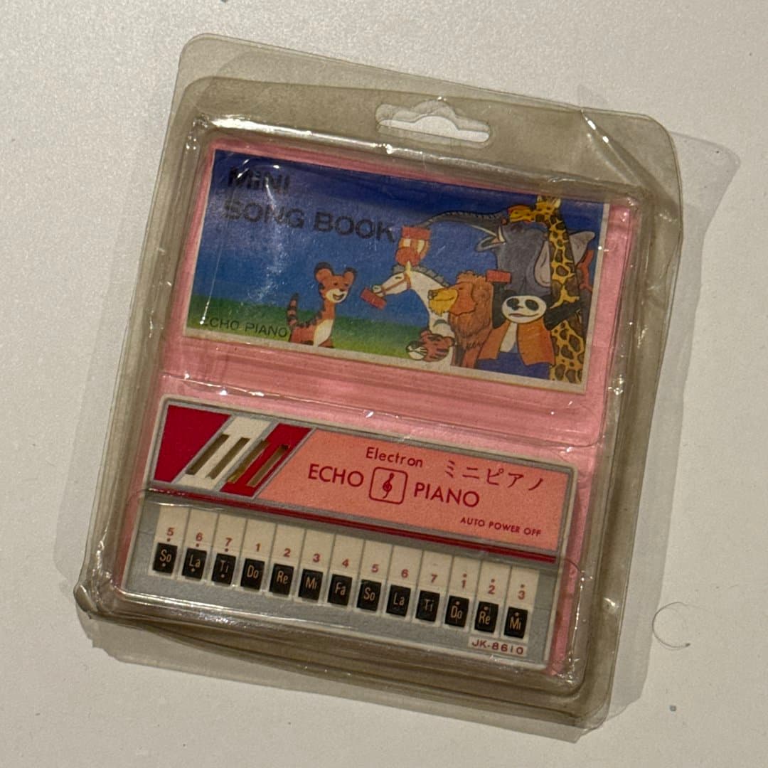 Children's electronic mini piano toy with songbook in original packaging.