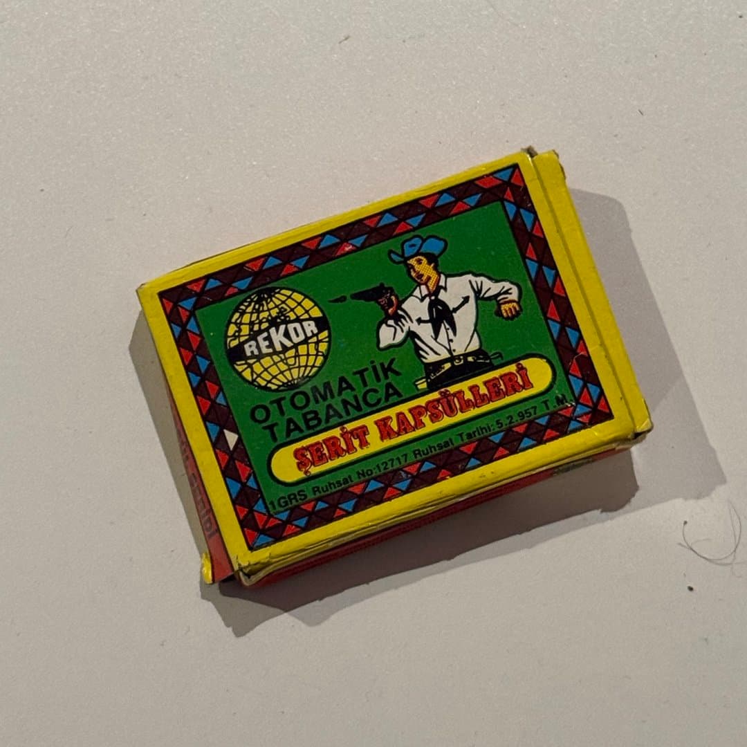 Vintage Rekor automatic pistol cap strips for toy guns, featuring a cowboy graphic.