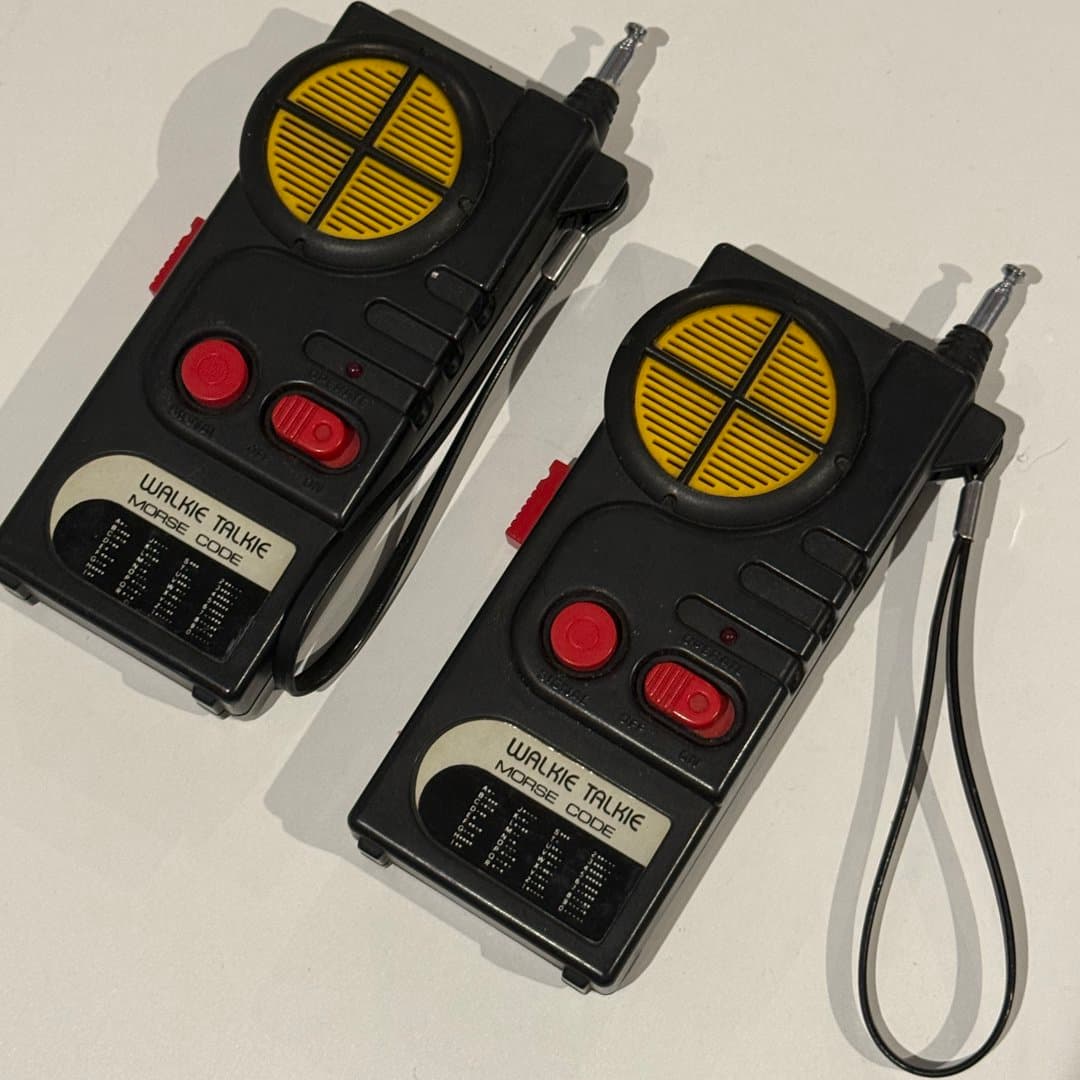 Vintage toy walkie-talkies with Morse code functionality for classic communication fun.