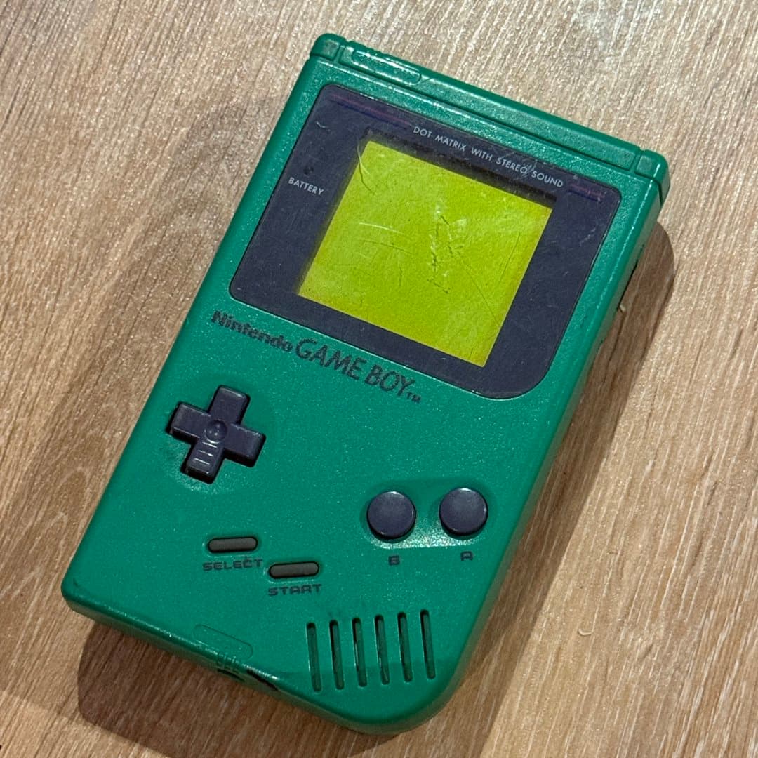 A vintage green Nintendo Game Boy handheld console, a classic portable gaming device. - Photo 1