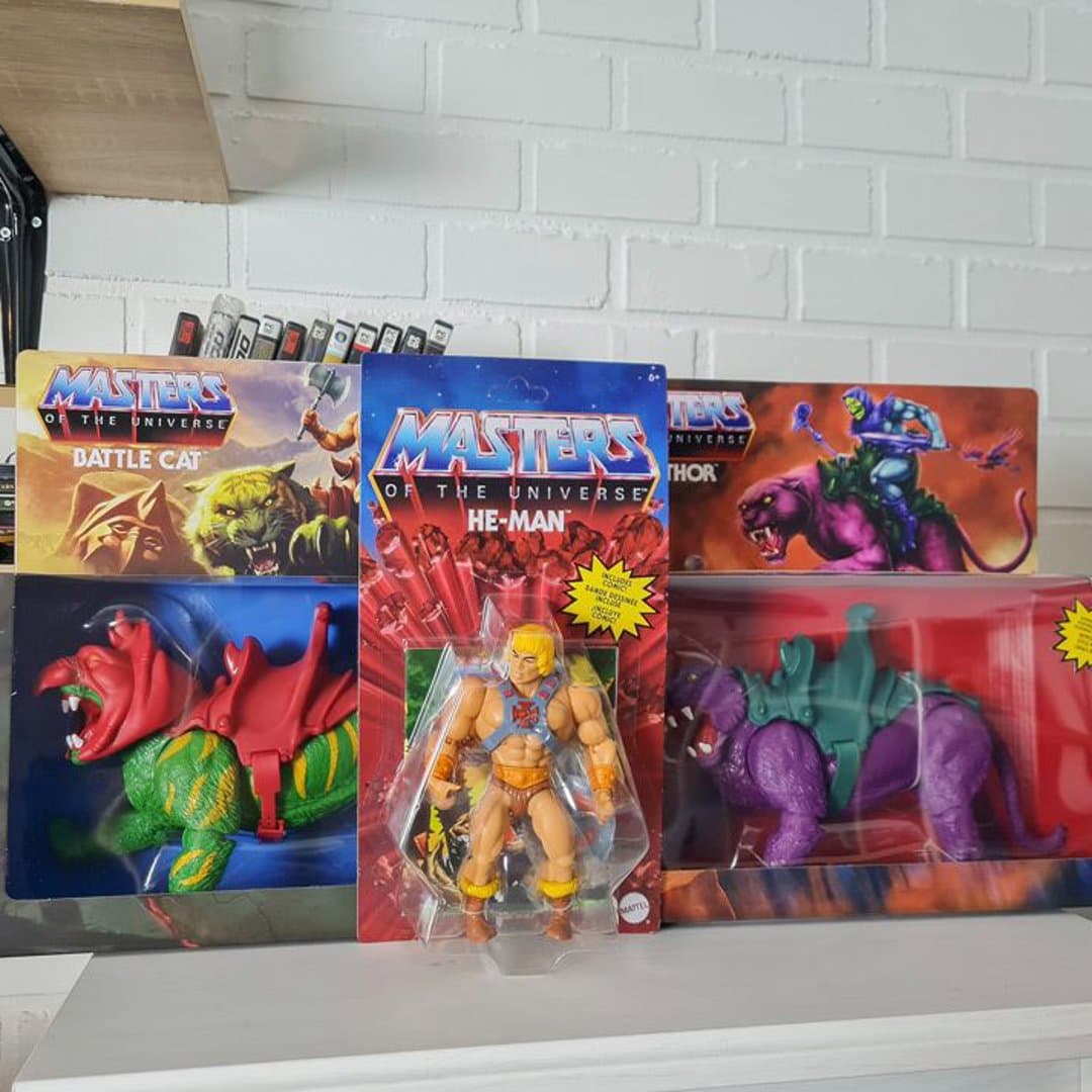 Masters of the Universe He-Man, Battle Cat, and Panthor collectible action figures.