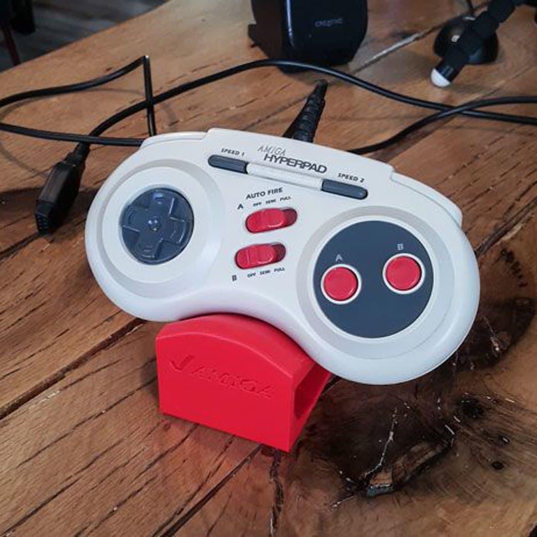 Vintage Amiga Hyperpad controller with auto-fire switches on a red Amiga stand.
