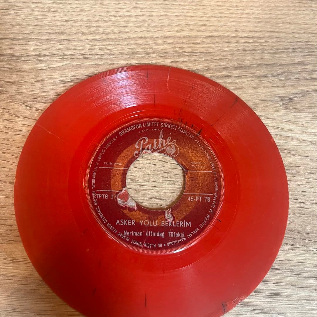 Vintage Turkish red vinyl 45 RPM record, "Asker Yolu Beklerim" by Neriman Altındağ Tüfekçi.