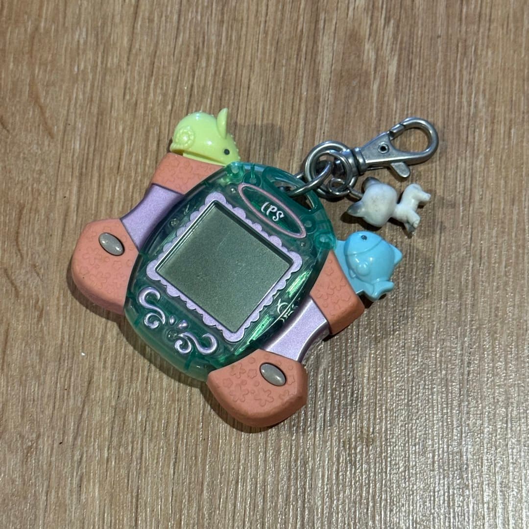 LPS electronic virtual pet keychain with animal charms, a nostalgic toy.