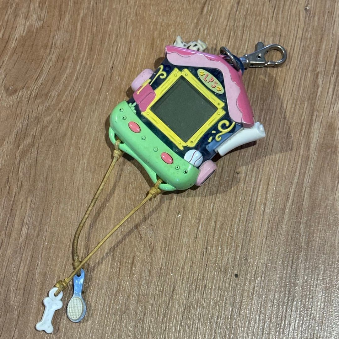 LPS virtual pet toy with a house design, screen, buttons, and pet care charms.