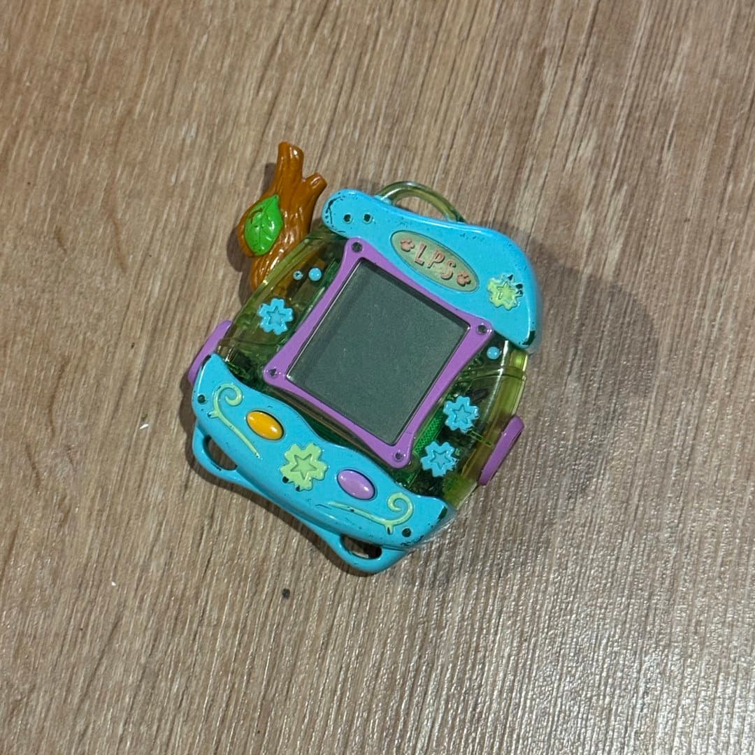 Littlest Pet Shop virtual pet game with a nature-themed design and screen.