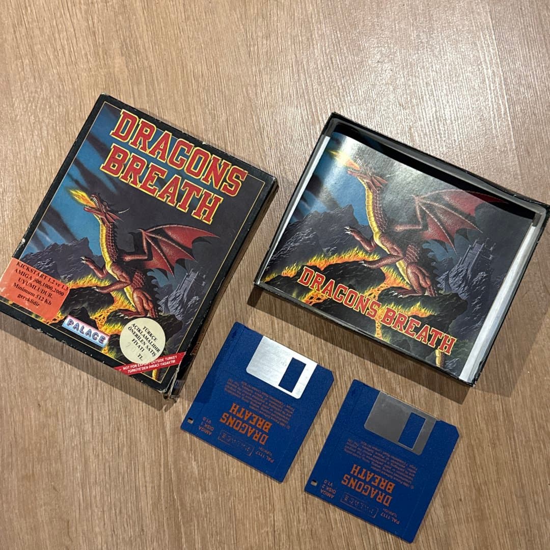 Vintage Amiga game 'Dragons Breath' on floppy disks, a classic 1990 title with Turkish localization.