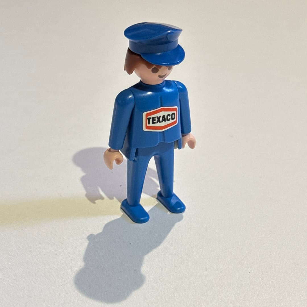 Vintage 1974 Playmobil Geobra Texaco gas station attendant figure in blue uniform.