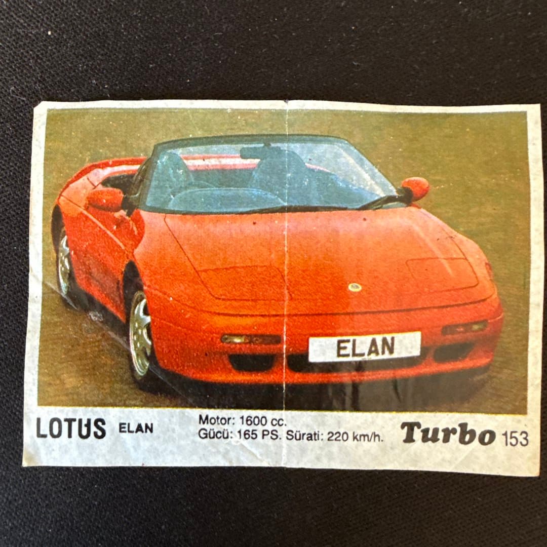 Collectible card featuring a red Lotus Elan sports car with engine and speed specifications. #153