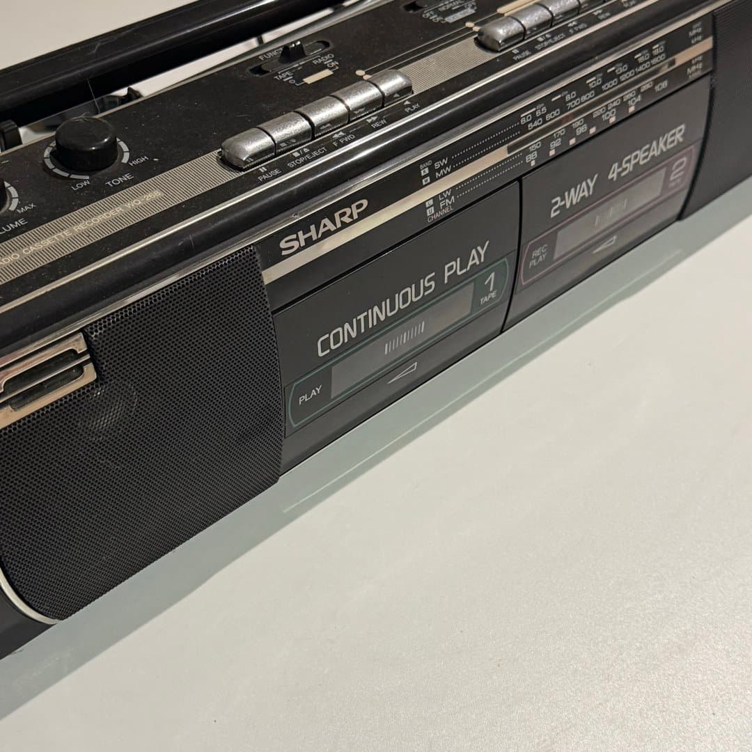 Vintage Sharp boombox with radio and cassette player, featuring continuous play. - Photo 1